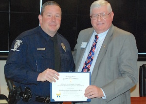 Mecklenburg chapter vice president Jim Prosser, on right, presents the SAR Law Enforcement Commendation Medal to CMPD police officer James Meadows.